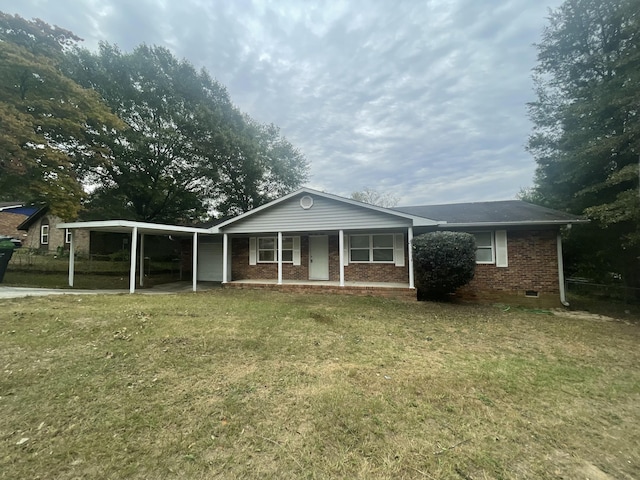 view of front of house featuring a carport, a front yard, and brick siding