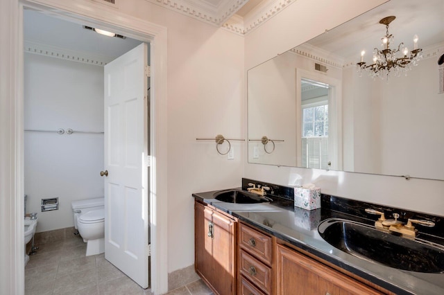 bathroom featuring vanity, toilet, a bidet, and a chandelier