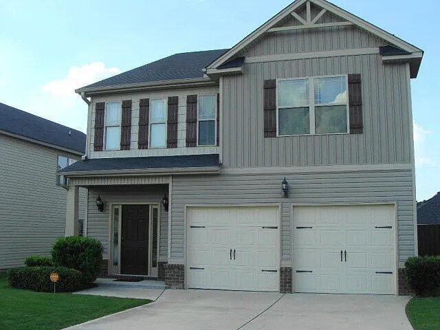 3321 Grove Landing Cir, Grovetown, GA 30813 - view of front facade featuring an attached garage, concrete driveway, and board and batten siding
