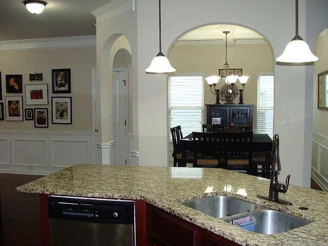 3321 Grove Landing Cir, Grovetown, GA 30813 - kitchen featuring a sink, stainless steel dishwasher, crown molding, a chandelier, and light stone counters