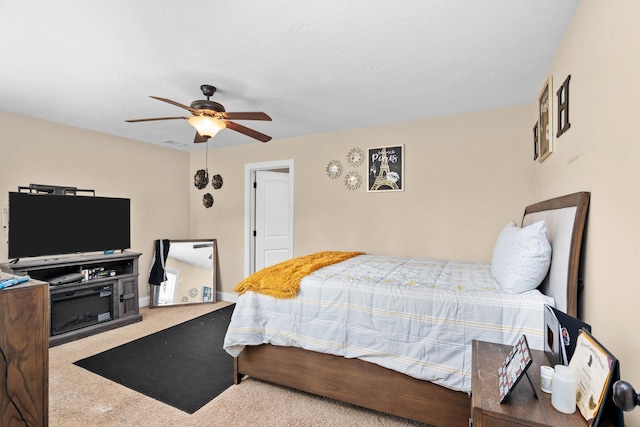 carpeted bedroom featuring visible vents, baseboards, and ceiling fan