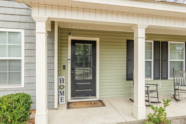 view of exterior entry featuring a porch