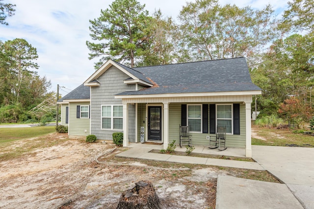 view of front of property featuring a porch and roof with shingles