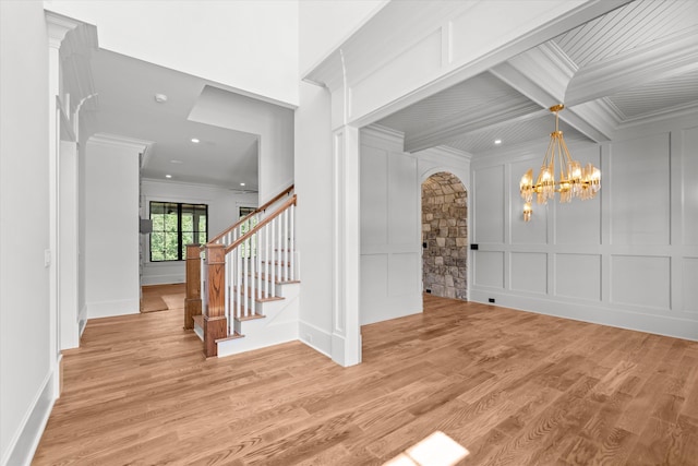 811 Audubon Way, Evans, GA 30809 - foyer with ornamental molding, a decorative wall, arched walkways, stairway, and light wood-type flooring
