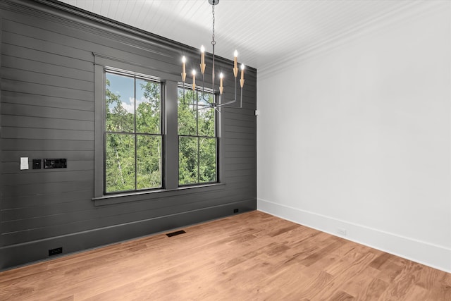 811 Audubon Way, Evans, GA 30809 - spare room featuring a chandelier, wooden walls, and light wood-type flooring
