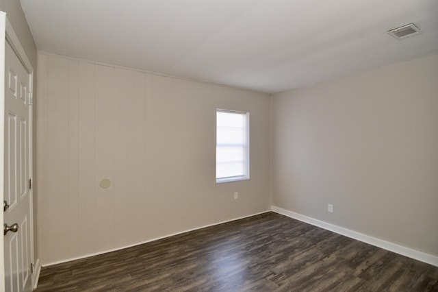 empty room featuring dark wood-type flooring