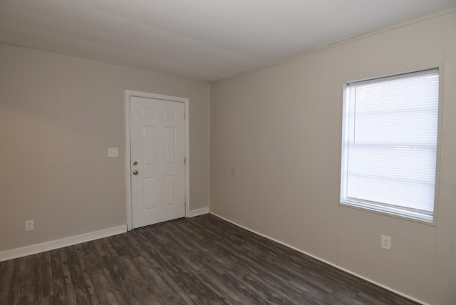 unfurnished room with a healthy amount of sunlight and dark hardwood / wood-style flooring