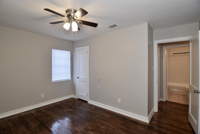 unfurnished bedroom featuring ceiling fan and dark hardwood / wood-style floors