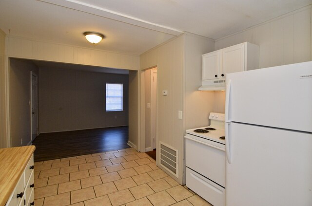 kitchen featuring white cabinets, white appliances, and light wood-type flooring