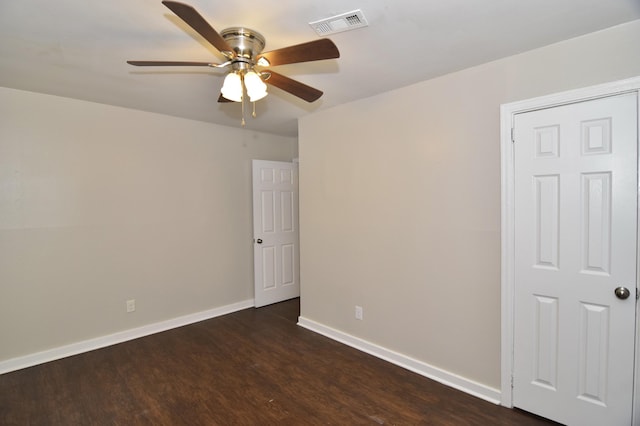 empty room featuring ceiling fan and dark wood-type flooring