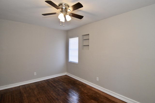 empty room featuring ceiling fan and dark hardwood / wood-style floors