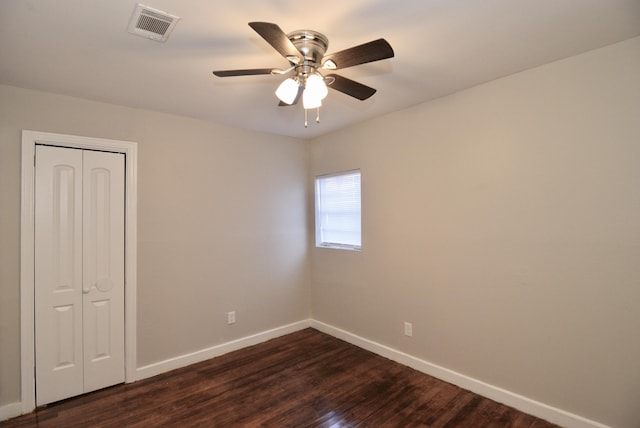 unfurnished room featuring dark hardwood / wood-style flooring and ceiling fan