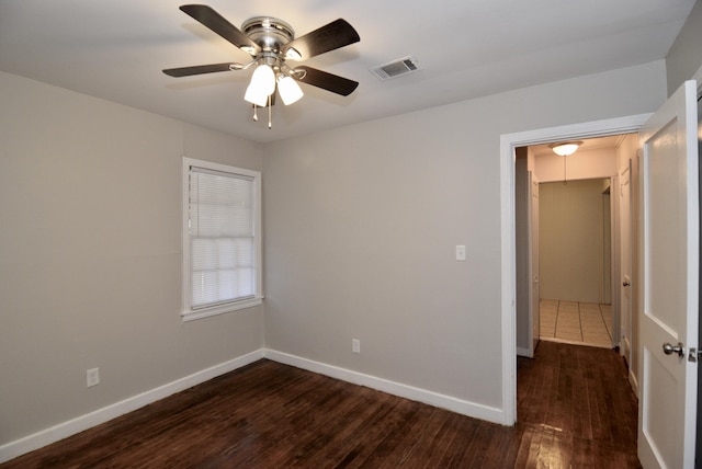 spare room featuring ceiling fan and dark hardwood / wood-style floors