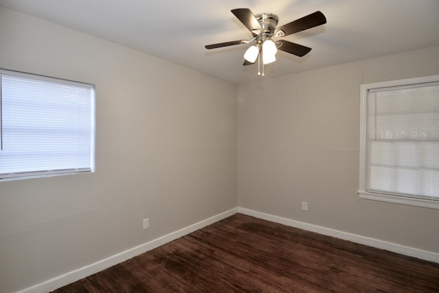 spare room featuring dark hardwood / wood-style flooring and ceiling fan