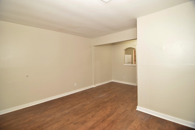 unfurnished room featuring dark wood-type flooring