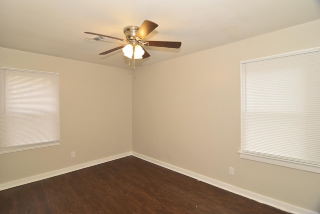 empty room featuring ceiling fan and dark wood-type flooring