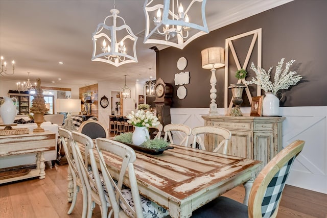 3121 Carillon Way, Evans, GA 30809 - dining space featuring a chandelier, ornamental molding, wainscoting, a decorative wall, and wood finished floors
