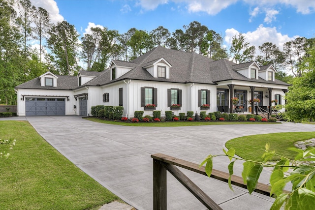 3121 Carillon Way, Evans, GA 30809 - view of front of house with driveway, board and batten siding, an attached garage, and a front lawn