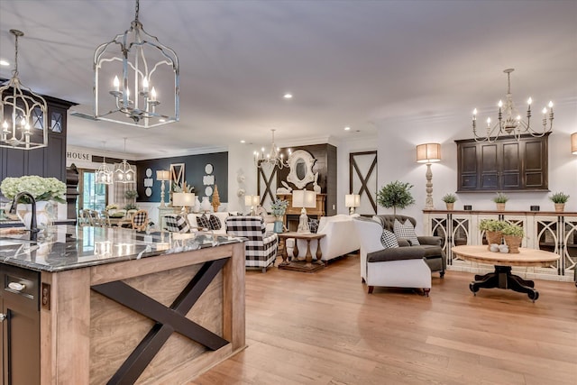 3121 Carillon Way, Evans, GA 30809 - kitchen with a chandelier, crown molding, light wood finished floors, open floor plan, and dark stone countertops