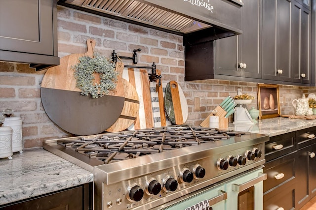 3121 Carillon Way, Evans, GA 30809 - kitchen with stove, decorative backsplash, custom range hood, and light stone countertops