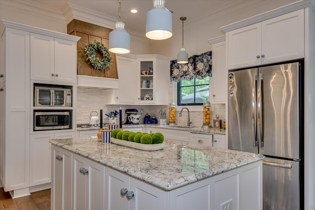 3121 Carillon Way, Evans, GA 30809 - kitchen featuring appliances with stainless steel finishes, white cabinets, a sink, a center island, and ornamental molding