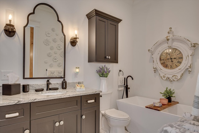 3121 Carillon Way, Evans, GA 30809 - bathroom with vanity, a freestanding bath, and toilet