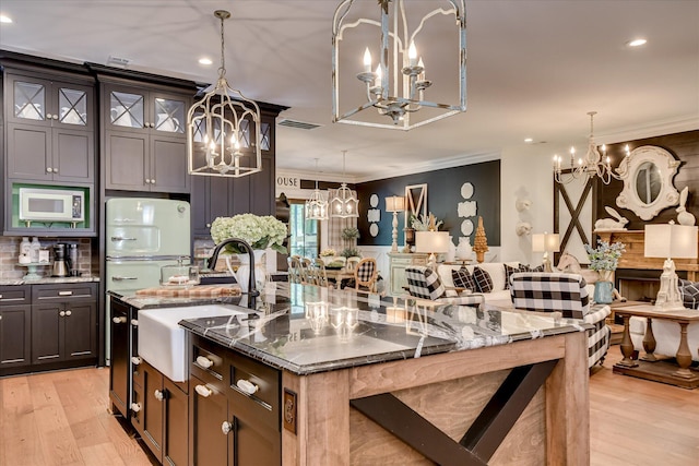 3121 Carillon Way, Evans, GA 30809 - kitchen featuring a chandelier, a sink, white appliances, crown molding, and a large island