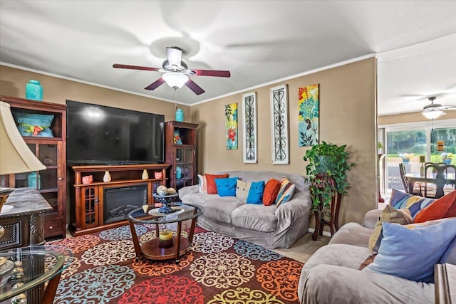 living room with ceiling fan and ornamental molding