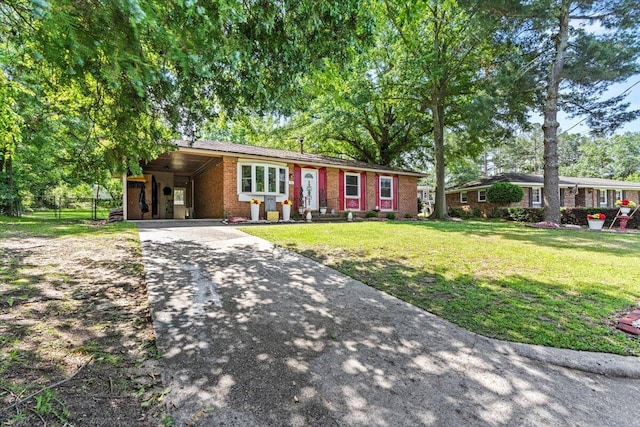 ranch-style house with concrete driveway, brick siding, a front lawn, and a carport