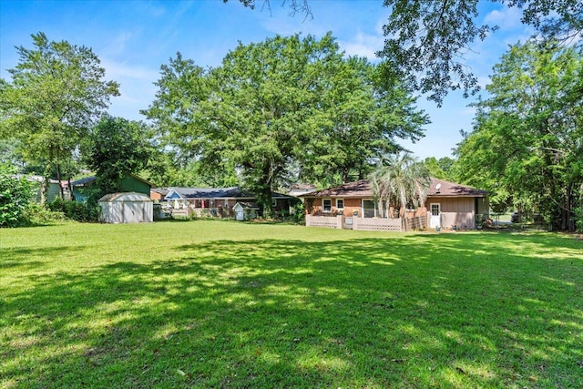 view of yard featuring a shed and an outdoor structure