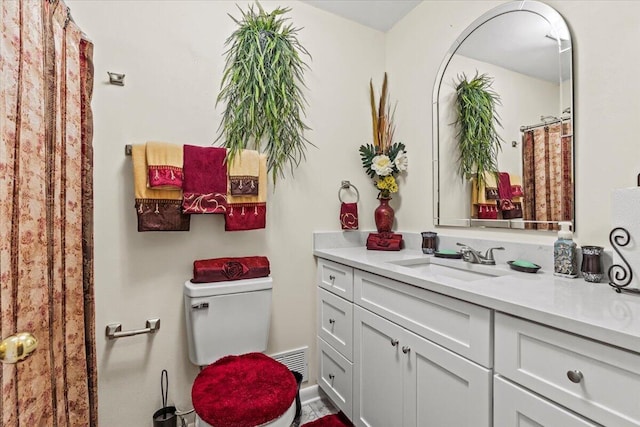 bathroom featuring vanity and toilet