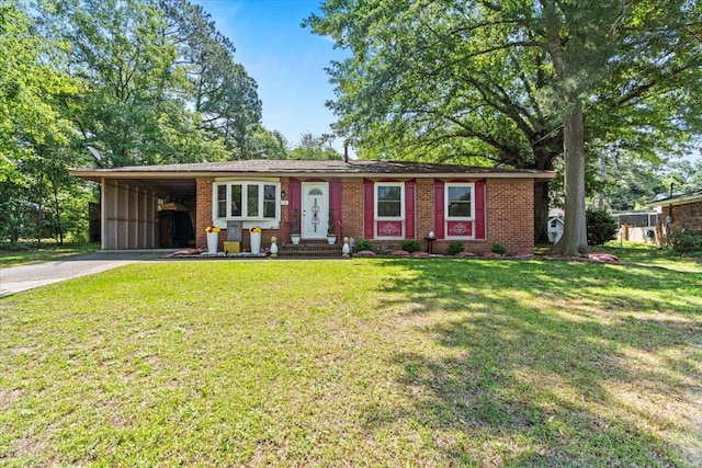 ranch-style home featuring driveway, an attached carport, brick siding, and a front lawn