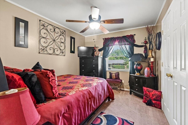 carpeted bedroom with ornamental molding and ceiling fan