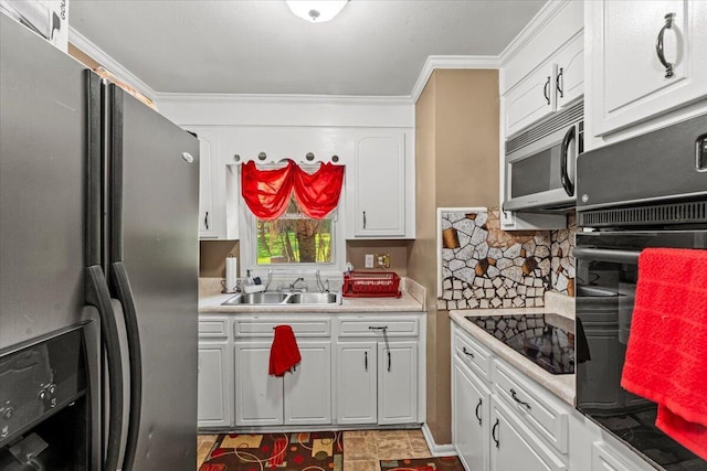 kitchen featuring black appliances, a sink, light countertops, white cabinetry, and ornamental molding