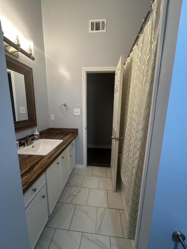4690 Red Leaf Way, Augusta, GA 30907 - full bathroom with vanity, marble finish floors, and a shower with curtain