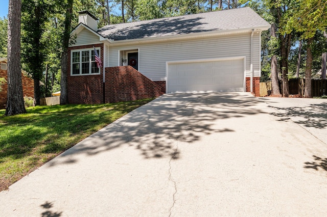 4690 Red Leaf Way, Augusta, GA 30907 - view of front of house featuring brick siding, a chimney, concrete driveway, and a garage