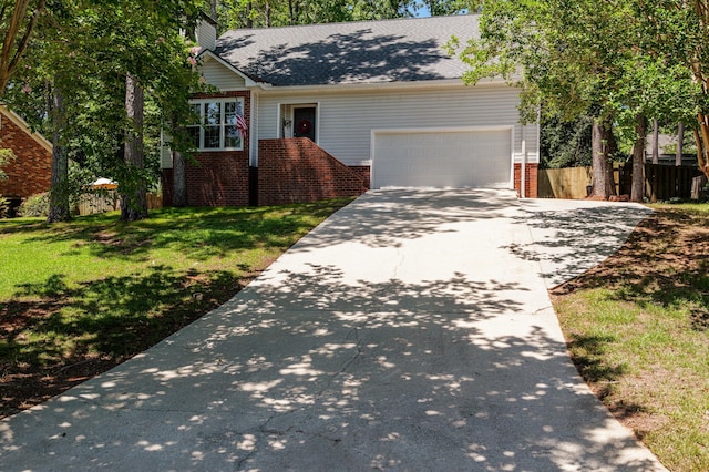 4690 Red Leaf Way, Augusta, GA 30907 - view of front of home featuring driveway, an attached garage, brick siding, roof with shingles, and a chimney