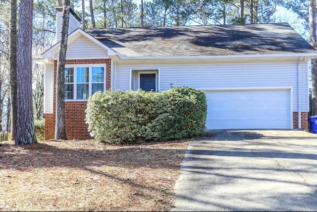 4690 Red Leaf Way, Augusta, GA 30907 - view of front of house with brick siding, a chimney, roof with shingles, and driveway