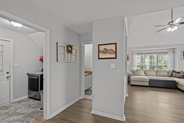 4690 Red Leaf Way, Augusta, GA 30907 - corridor featuring light wood-type flooring, baseboards, a textured ceiling, and washer / dryer