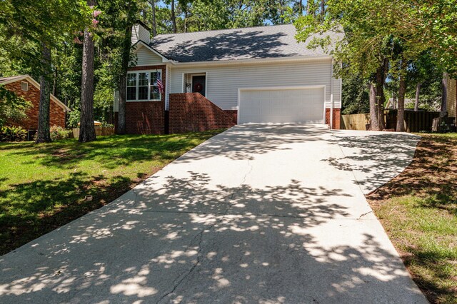 4690 Red Leaf Way, Augusta, GA 30907 - view of front of home featuring brick siding, concrete driveway, an attached garage, and a chimney