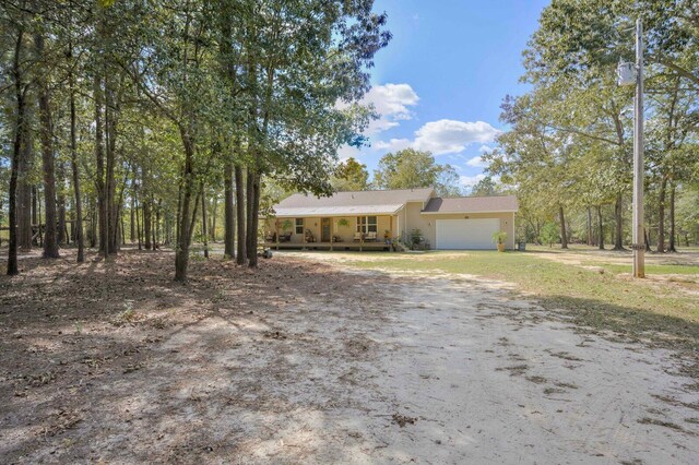 view of front of home featuring a porch and a garage