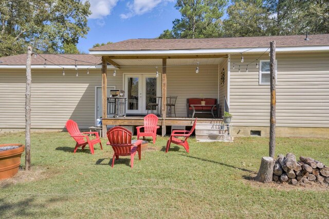 rear view of house with a yard and french doors