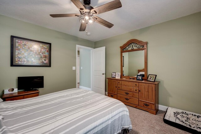 bedroom featuring ceiling fan and light carpet