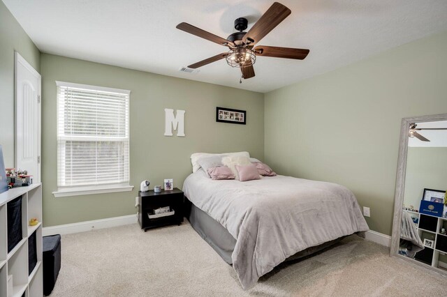 carpeted bedroom with ceiling fan