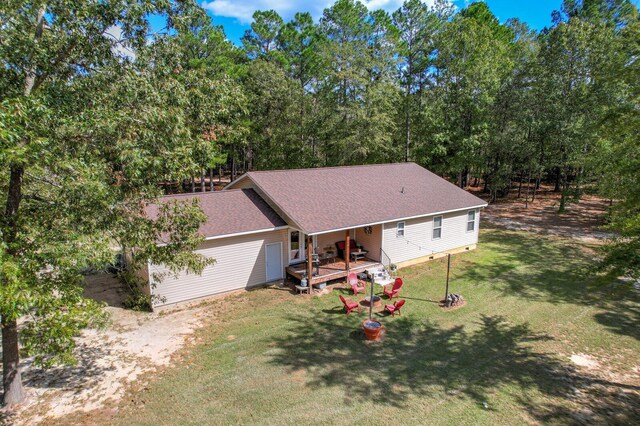 view of front of property featuring a front yard and a deck