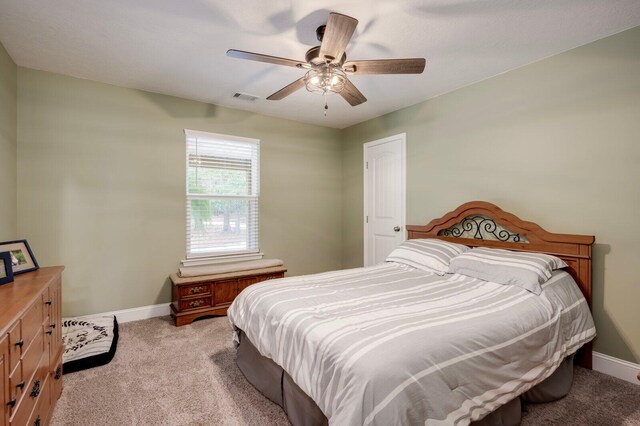 bedroom with ceiling fan and light colored carpet