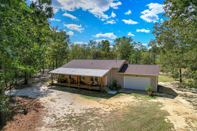 view of front facade featuring covered porch and a garage