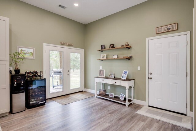 entrance foyer featuring french doors and light hardwood / wood-style flooring