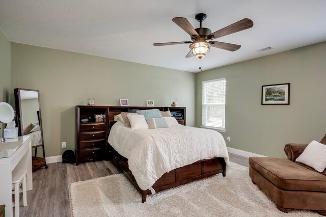 bedroom featuring light hardwood / wood-style flooring and ceiling fan