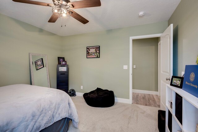 bedroom featuring ceiling fan and light carpet